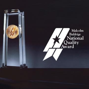 A photo of the Malcolm Baldridge Award and Logo